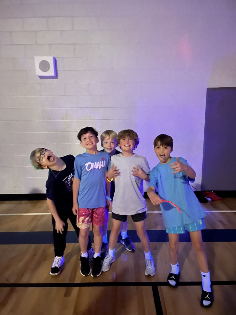 4th grade boys pose for a silly photo during the dance party. 