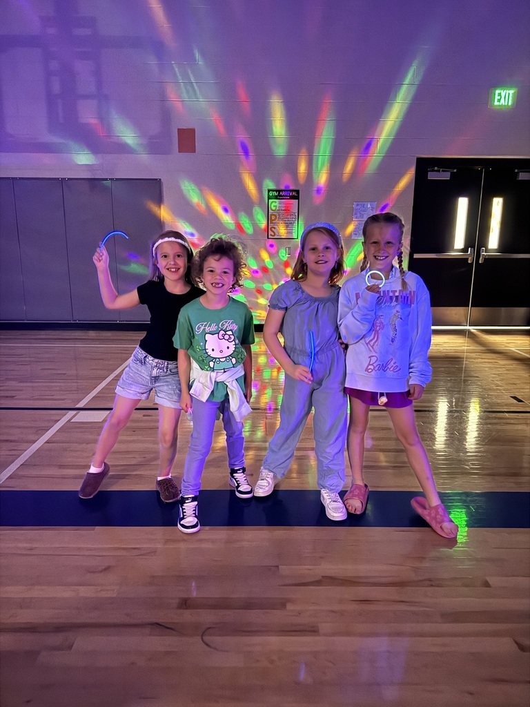 1st grade girls smile with their glow sticks! 