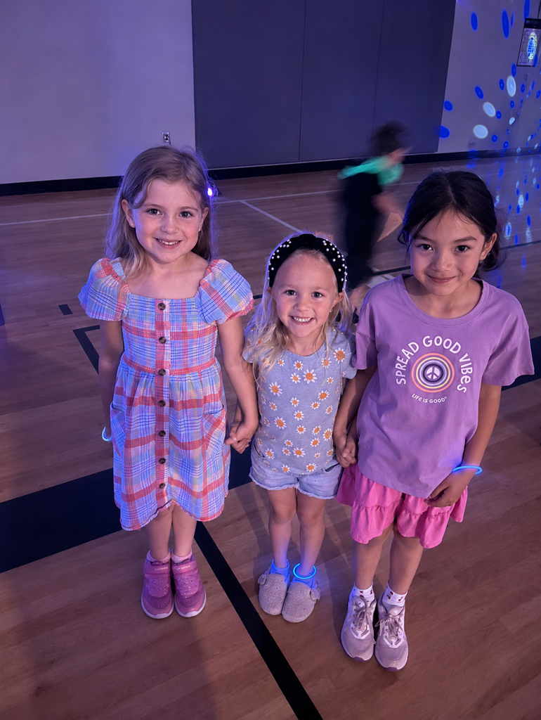 Kindergarten girls pose for a photo during the dance party. 