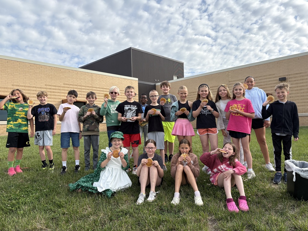 students eating pioneer themed food outside