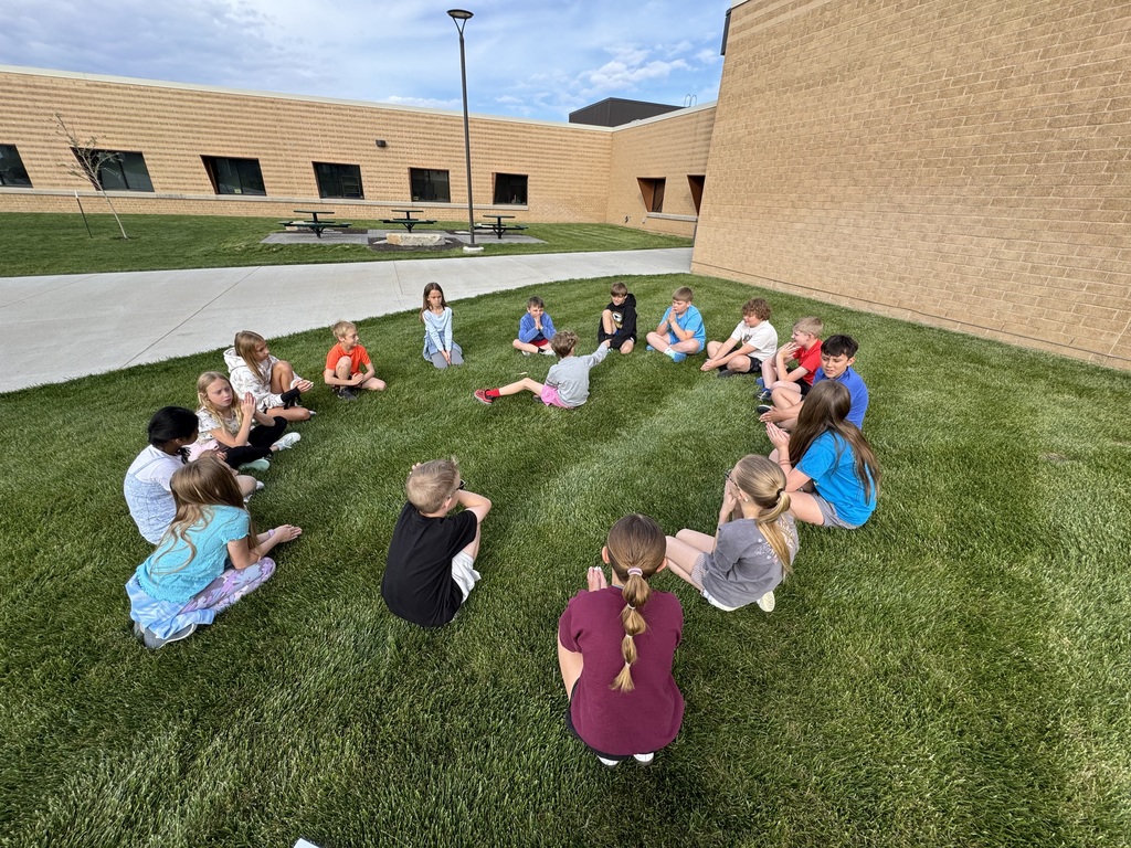 students playing a game outside in a circle