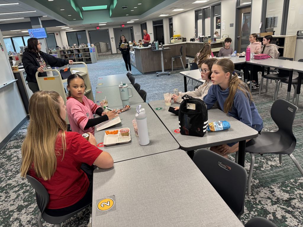 Four students sit at a table. 