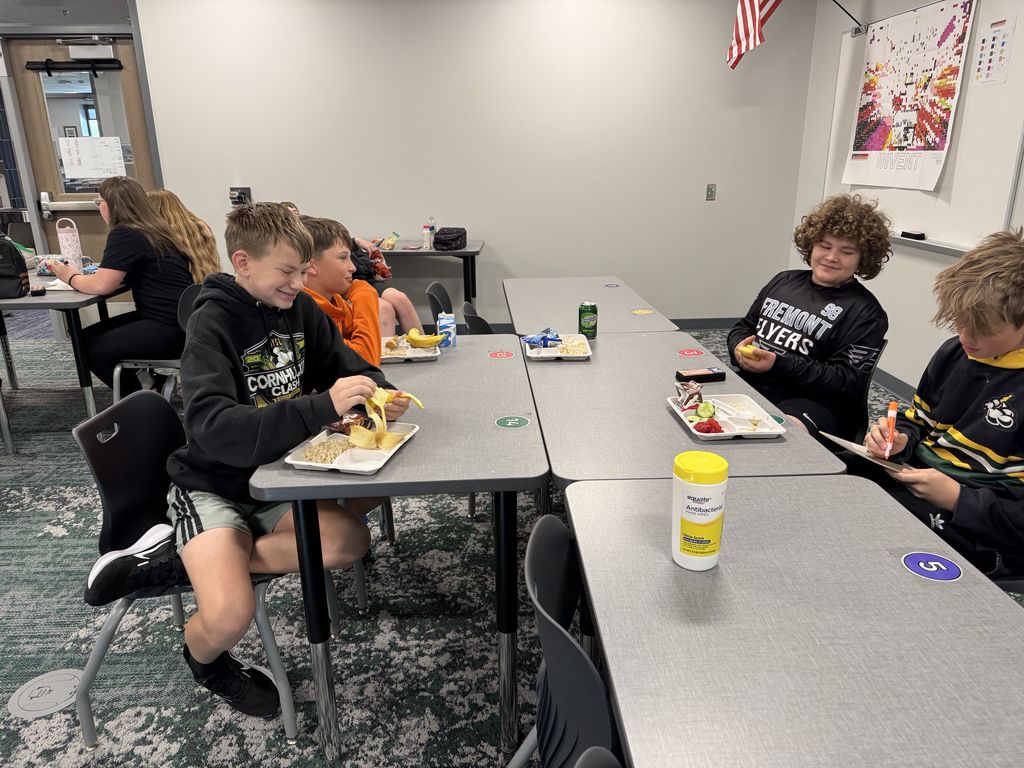 Four students sit at a table. 