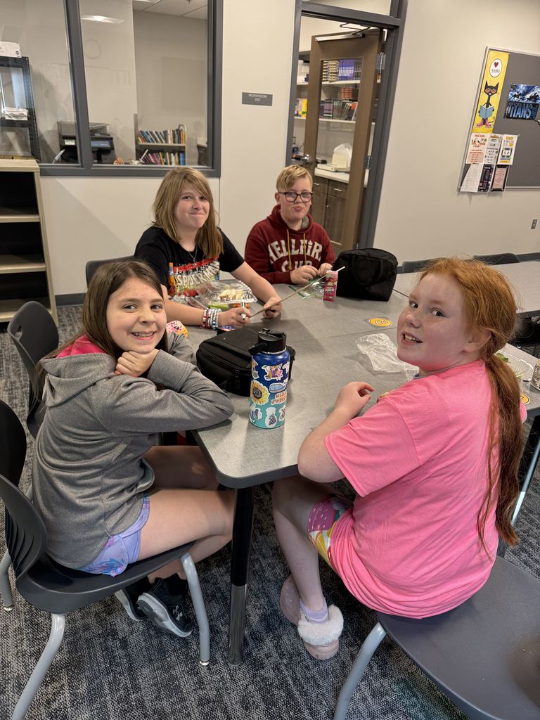 Four students sit at a table. 
