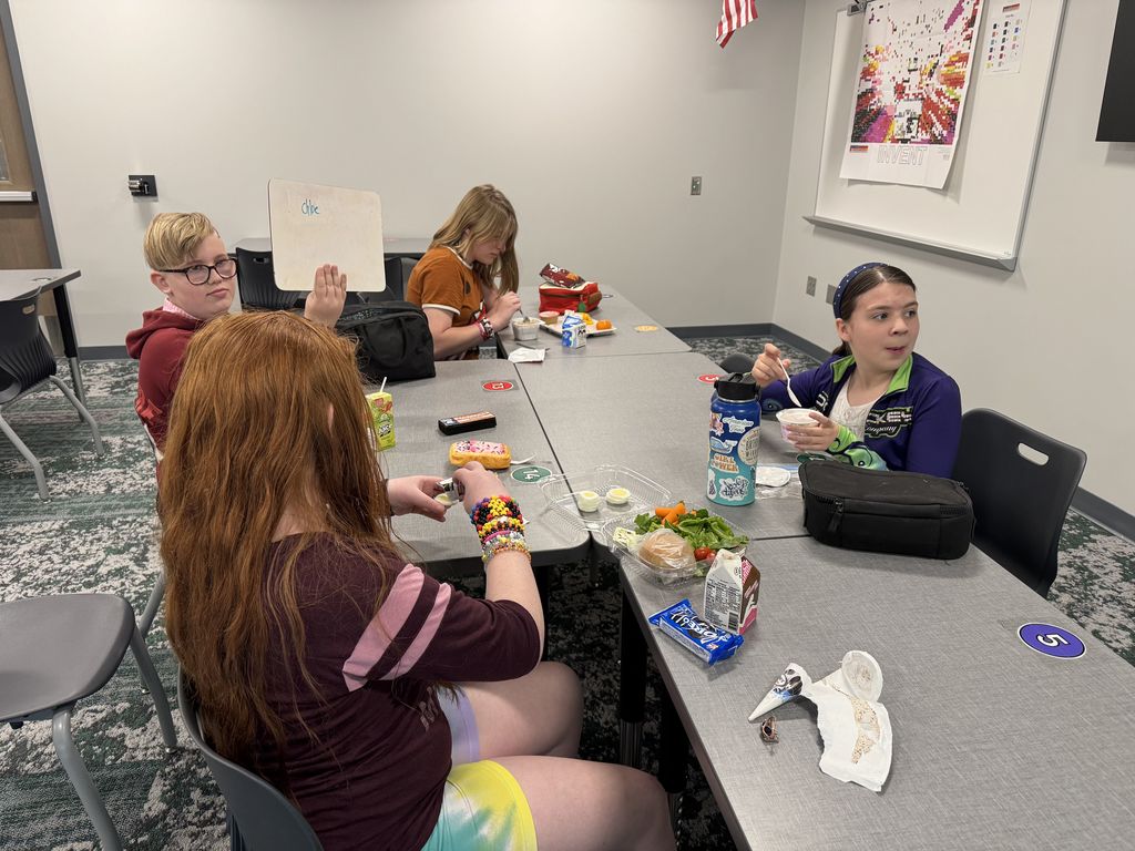 Four students sit at a table. 