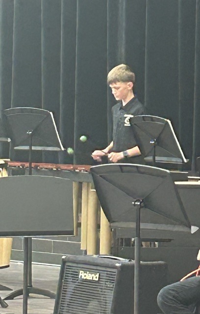Photo of a percussionist with mallets in his hands playing.