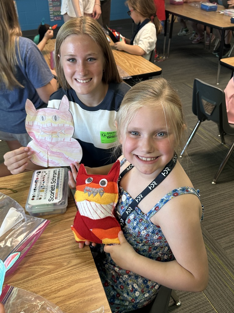 Photo of an 8th grader with a kindergartener and her monster.