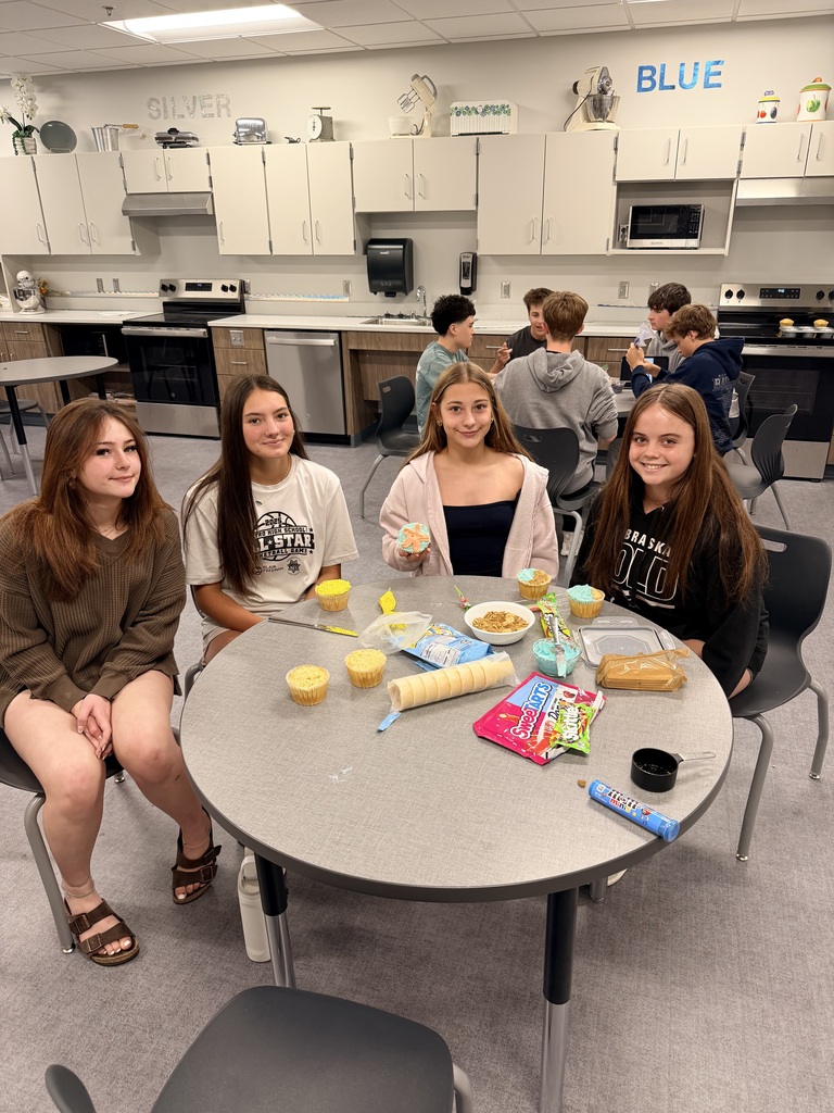A group of girls look at the camera and smile. 