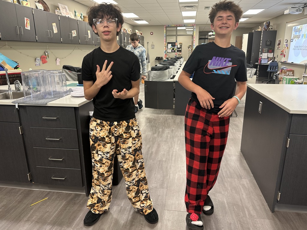 Photo of two students wearing their pajama pants.