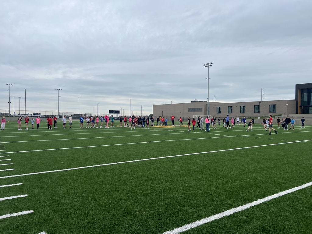 Photo of students playing kickball on the turf field.