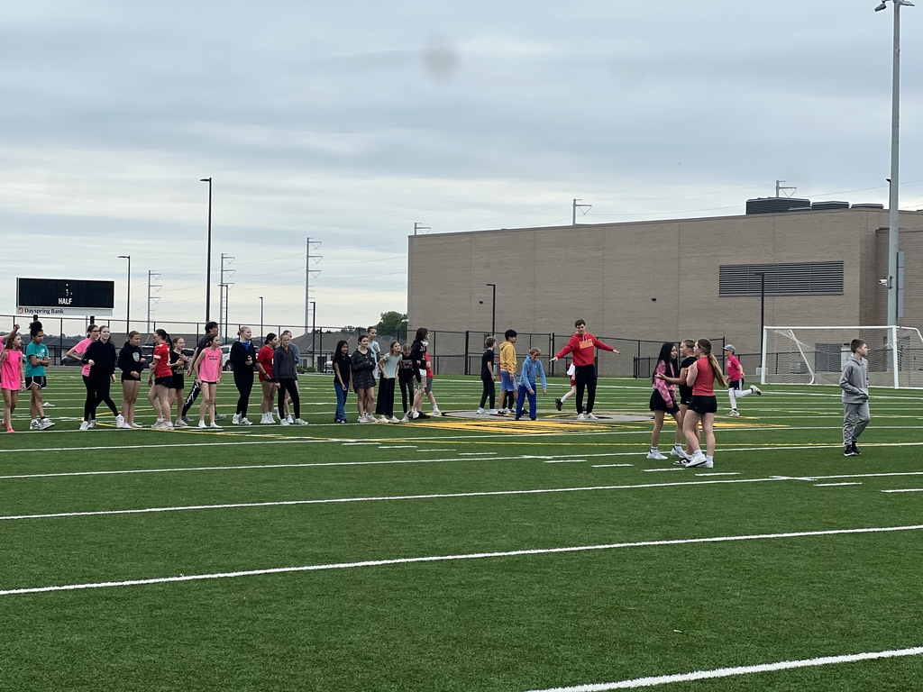 Photo of teacher directing students on the kickball field.