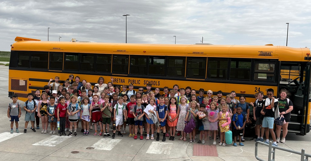 students in front of the bus