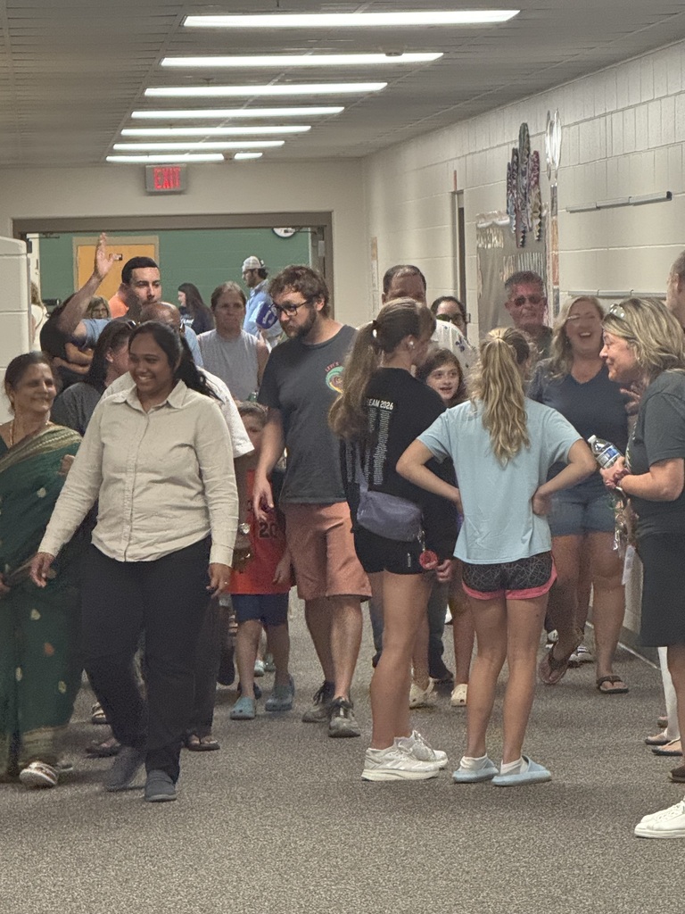 Thomas families walking through the halls at open house.