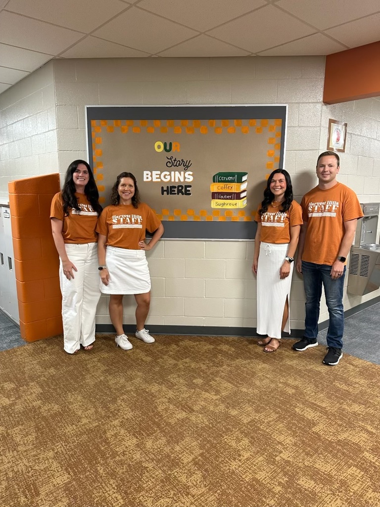 teachers smiling in matching shirts in the hallway