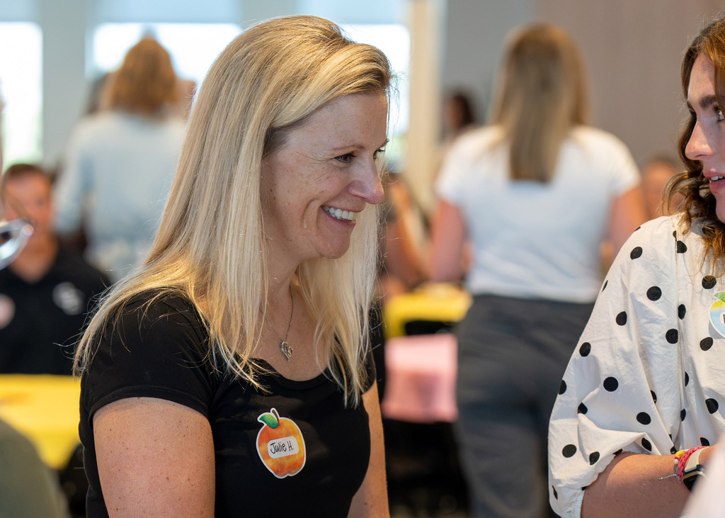 Gretna Public Schools new teacher smiling at another teacher at breakfast