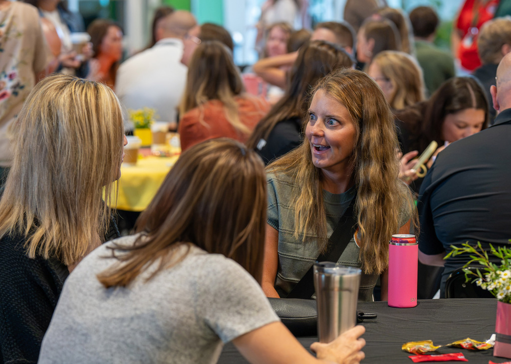a group of new staff members talking together at breakfast gathering