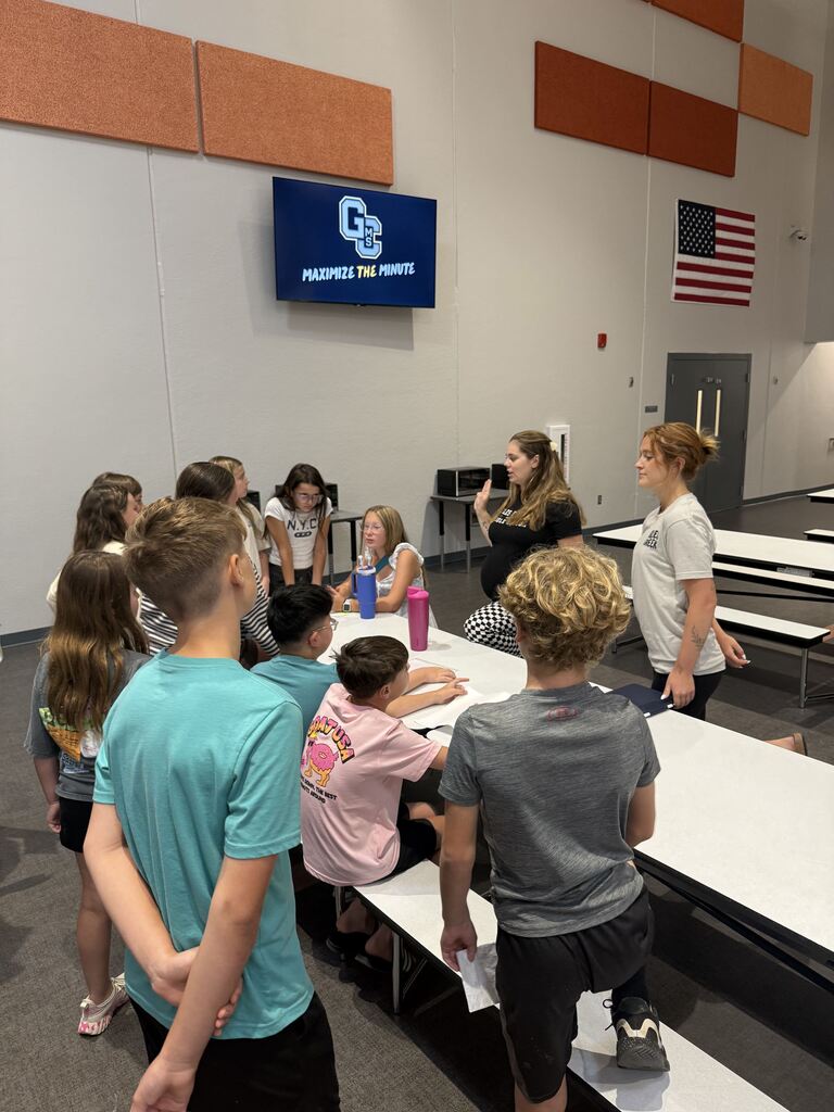 Kids and teachers in the lunchroom. 