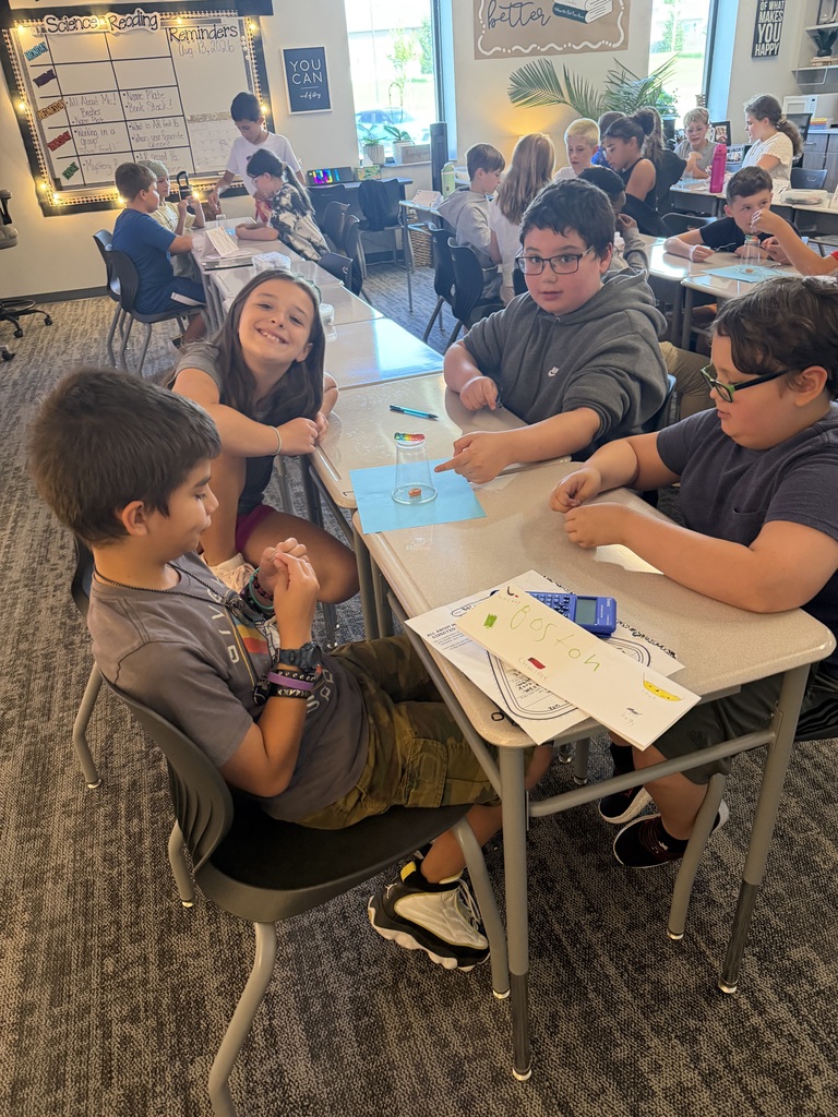 A group of student working at tables. 