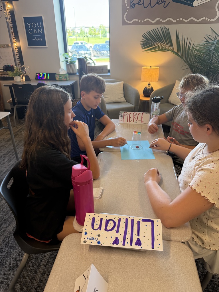 A group of student working at tables. 