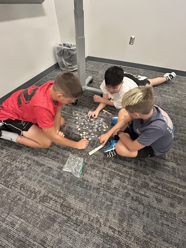 Students working on a puzzle. 