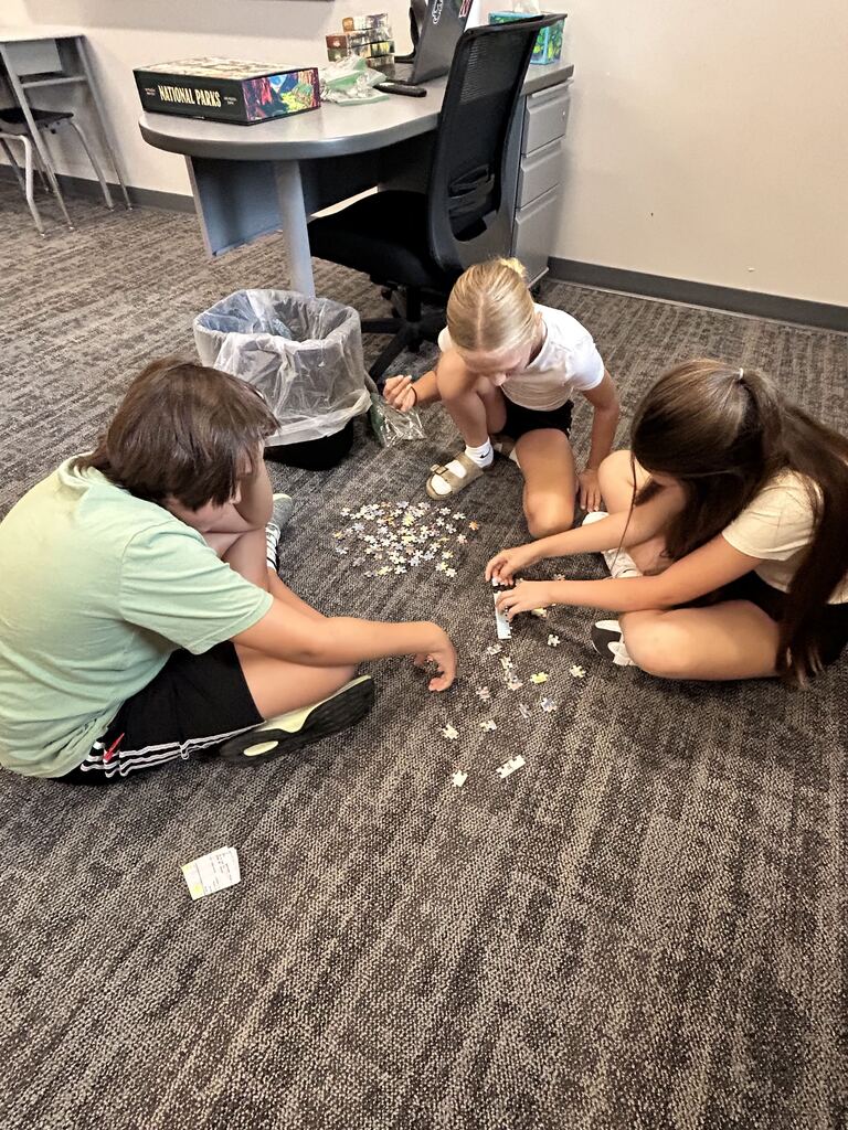 Students working on a puzzle. 