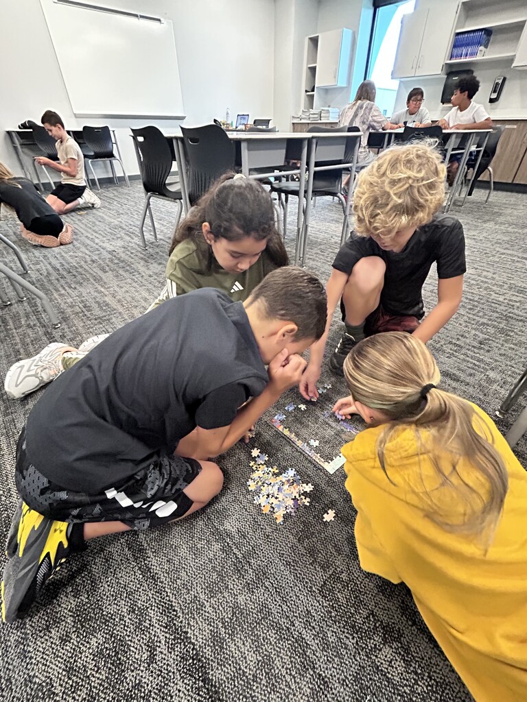 Students working on a puzzle. 