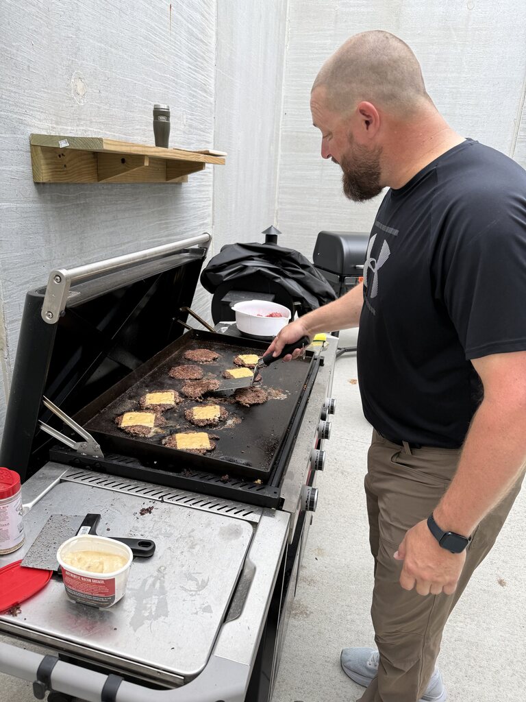 A man grilling.
