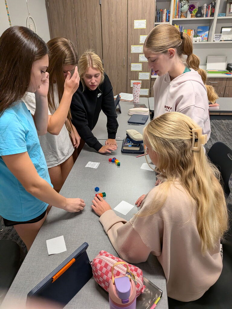 Students working on a project at a table. 