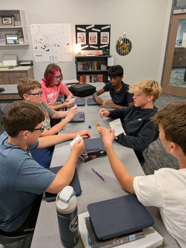 Students working on a project at a table. 
