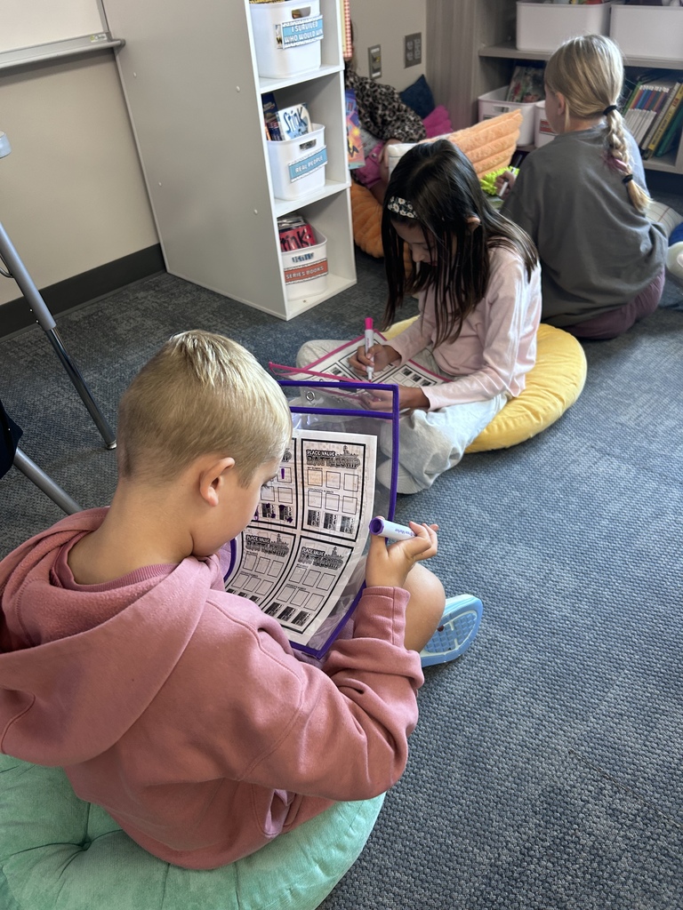 students playing curriculum battleship on a classroom floor