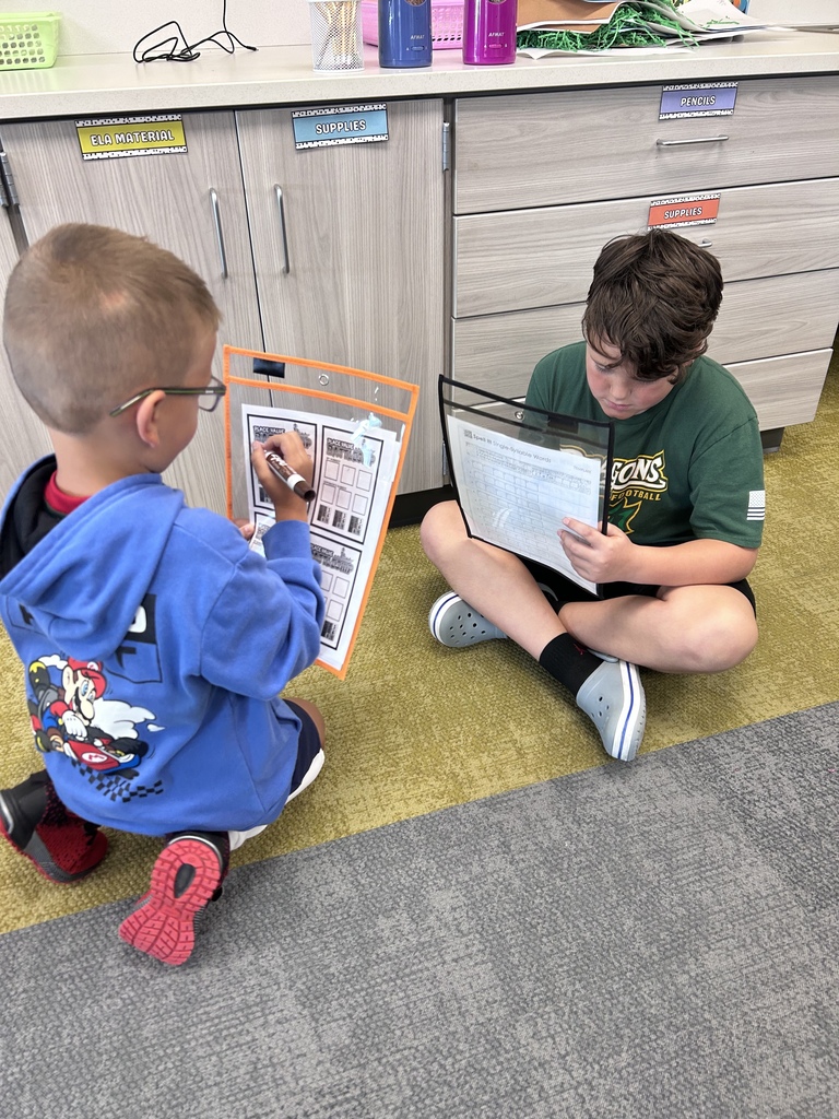 students playing curriculum battleship on a classroom floor