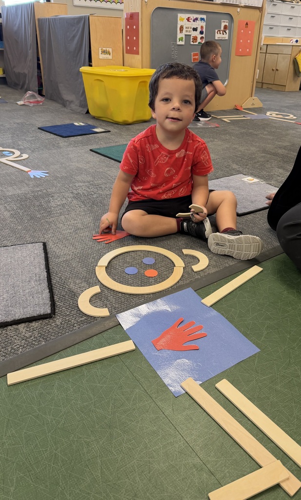 preschooler with mat man on the floor