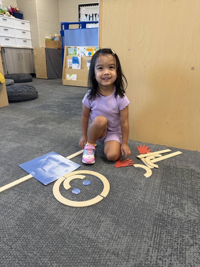 preschooler with mat man on the floor