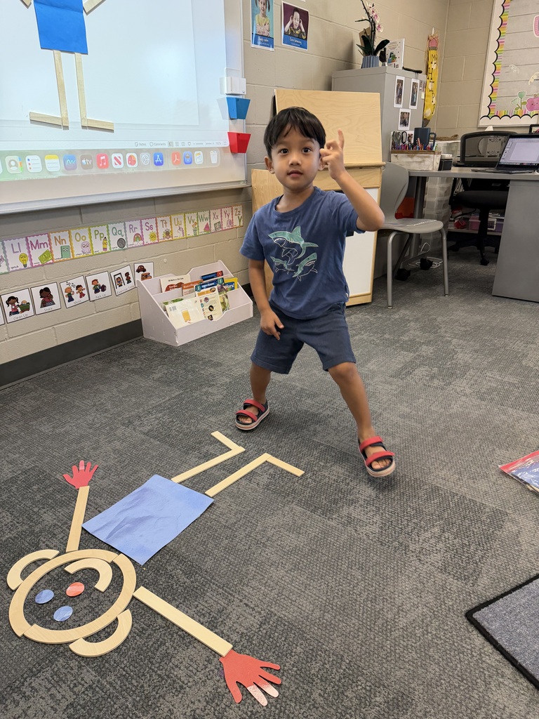 preschooler with mat man on the floor