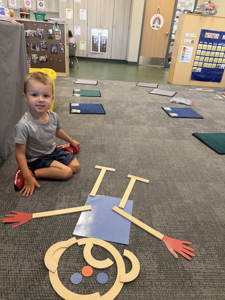 preschooler with mat man on the floor