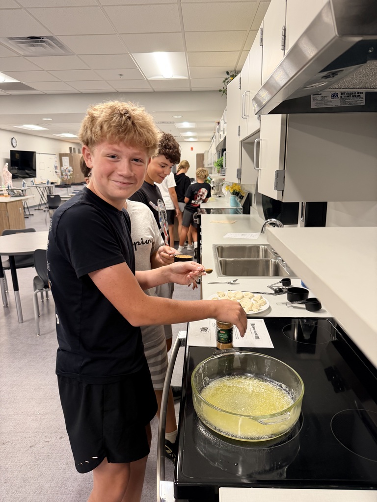 A student smiling at the oven.