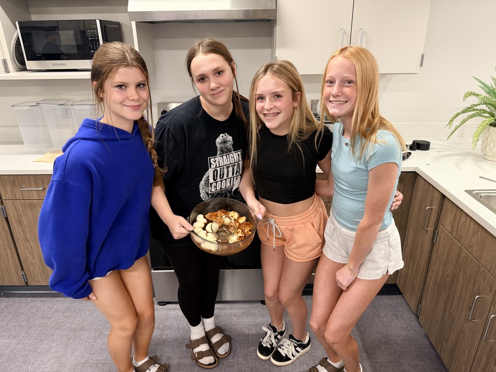 Students smiling and baking.