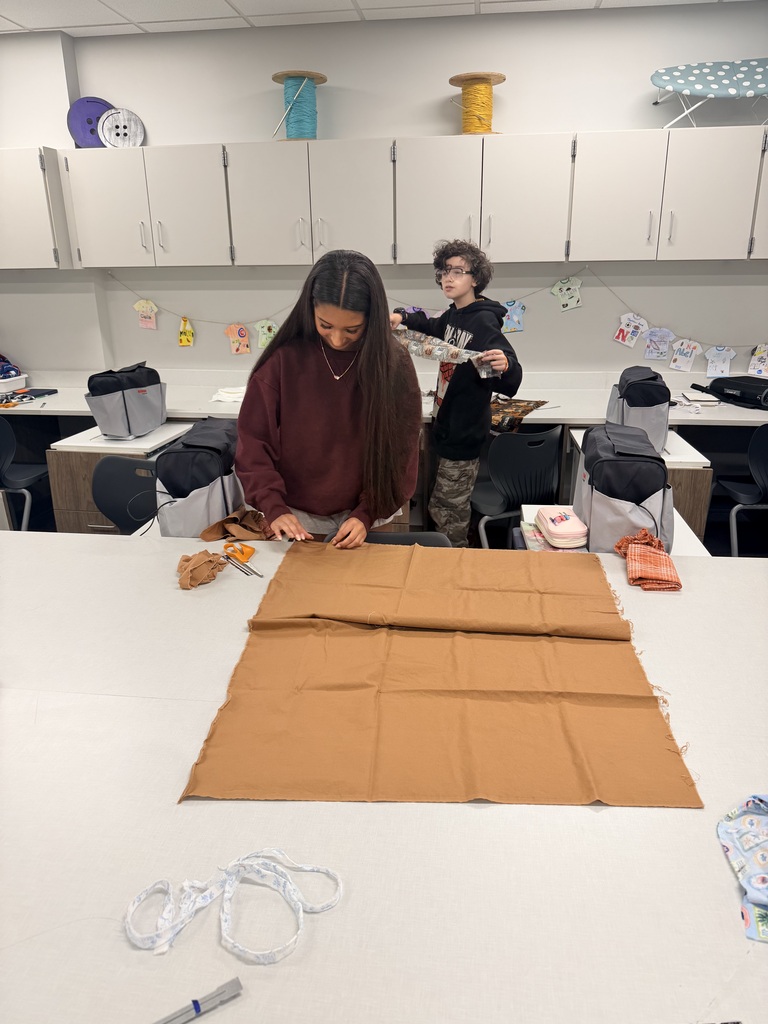 Students working on cutting out fabric.