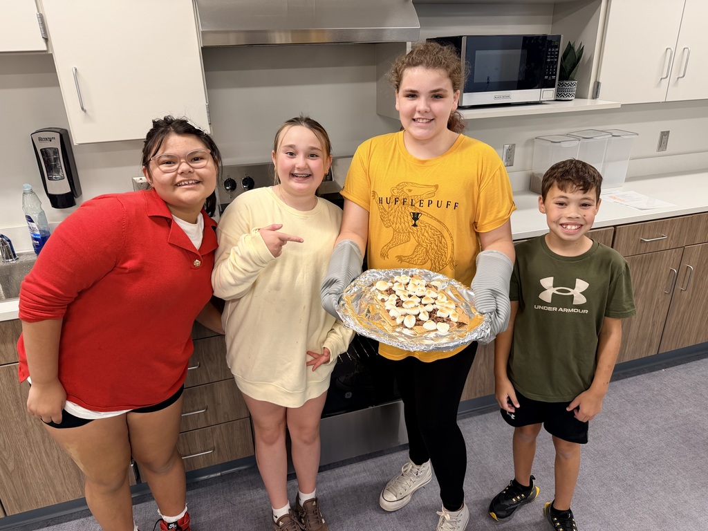 A group of students holding a plate of smores nachos.