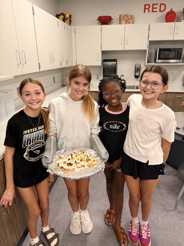 A group of students smiling with smores nachos.