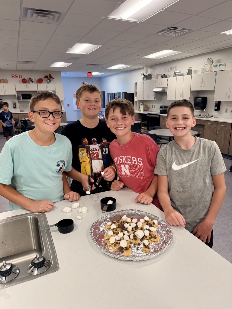 A group of students smiling with smores nachos.