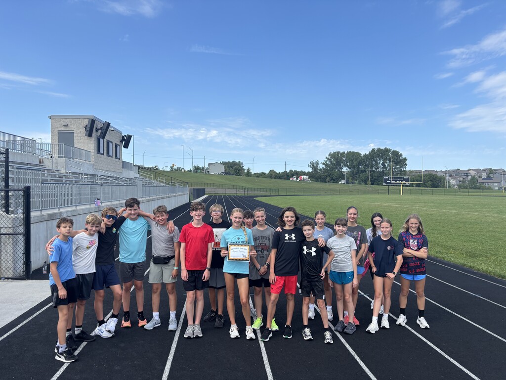 A group of students standing on a track.