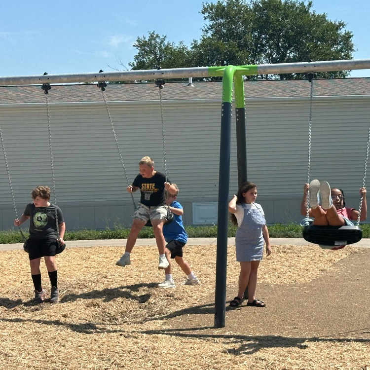 children swinging on a swingset