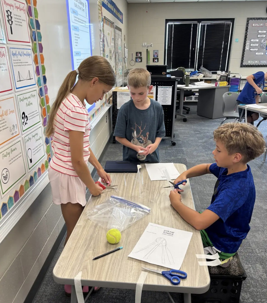 students working on a stem project with straws
