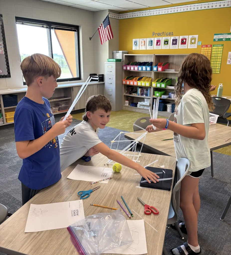 students working on a stem project with straws