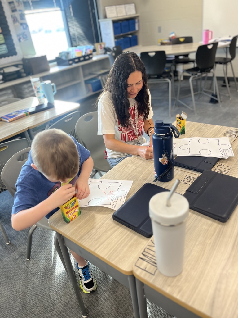 student and teacher working on a coloring puzzle project in class