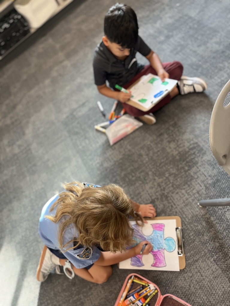 students coloring a jigsaw puzzle picture