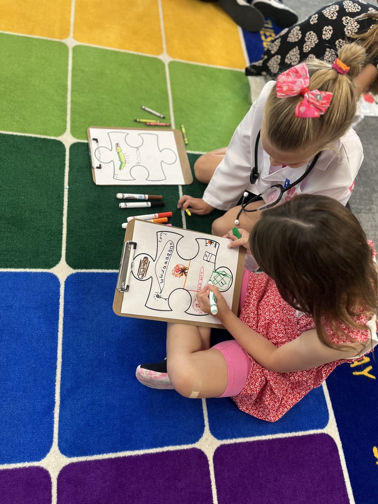 students working on a puzzle piece coloring project in a classroom