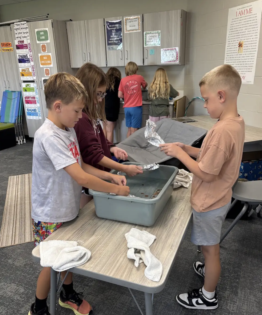 students working on floating foil boats in a HAL classroom
