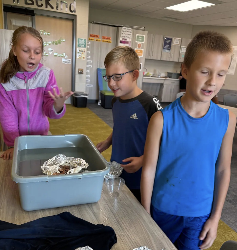 students working on a STEM project with floating foil